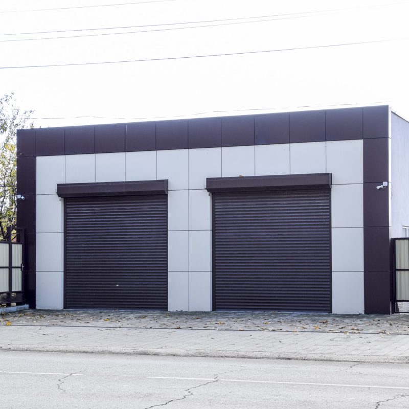 Garage for two cars with roller shutter. Modern gate in the garage with roller blinds.