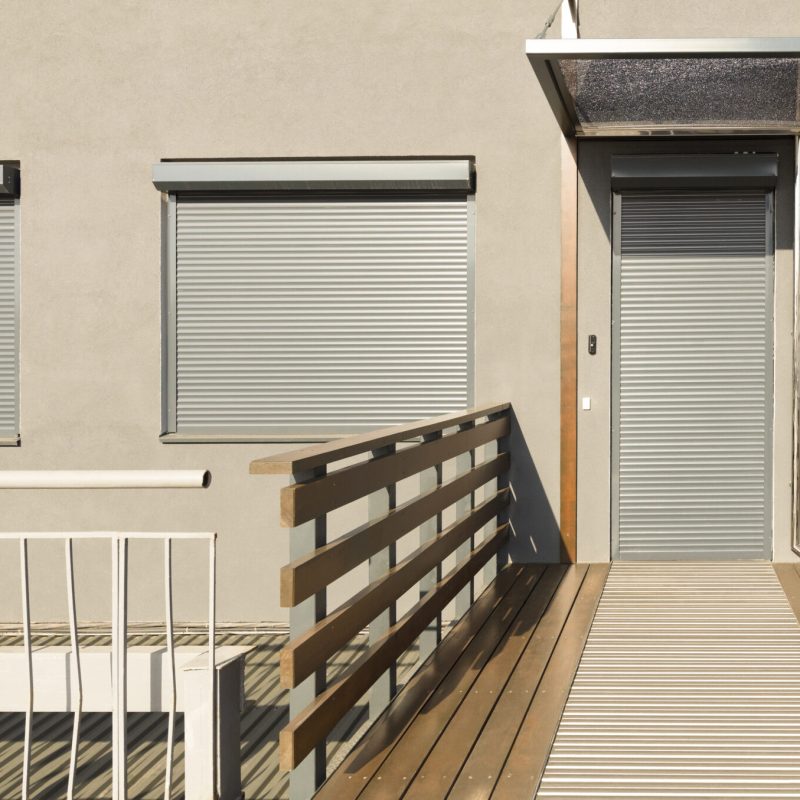 Light beige metal blinds on the doors and windows of the house