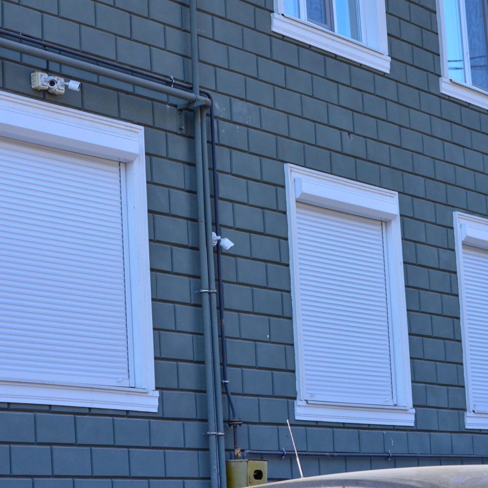 three-white-windows-gray-brick-wall-windows-are-closed